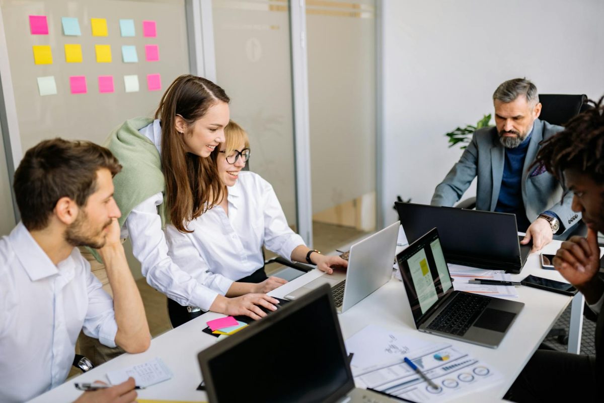 Diverse team of business professionals collaborating in a modern office setting.